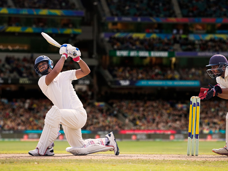 A cricketer playing a shot during a match