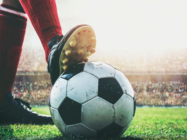 Close-up of a footballer striking the ball